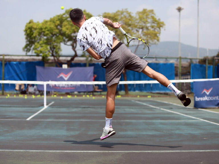 tennic coach vincent with serving from back view