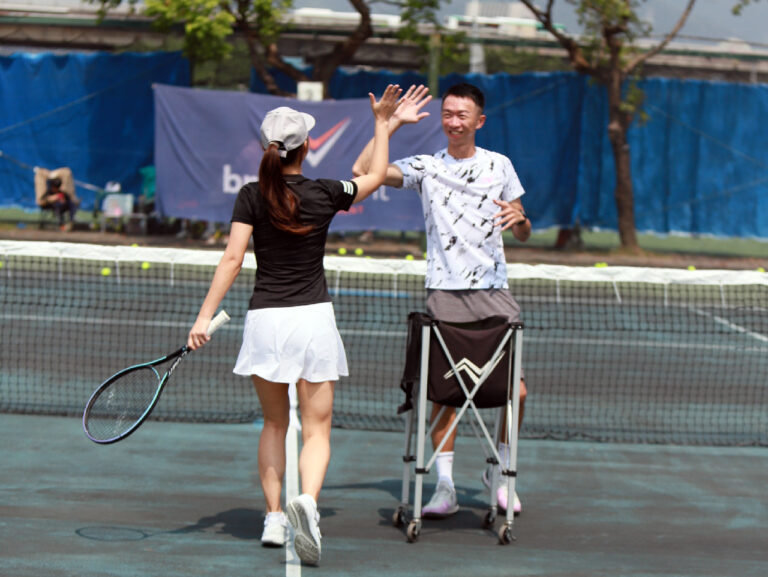 tennis coach Vincent high five with student
